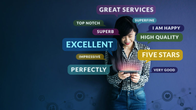 Woman holding device surrounded by words indicating good customer experience